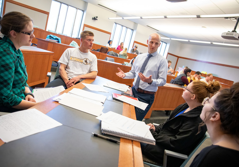 Professor helping students in class