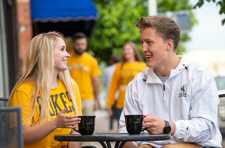 two University of Wyoming students enjoy coffee together