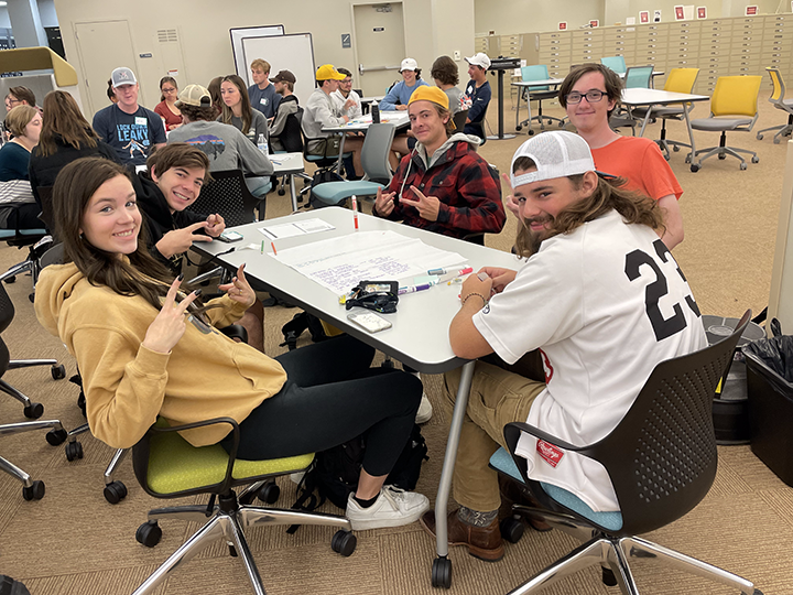 students in a Fall Bridge class work together at a table.