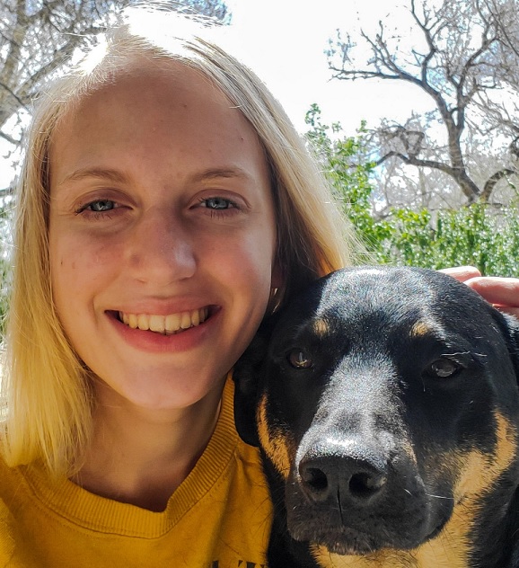 student with black dog