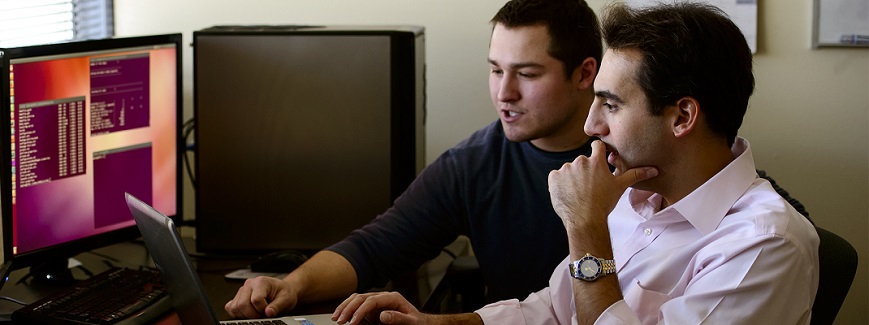 Image of two men looking at computer