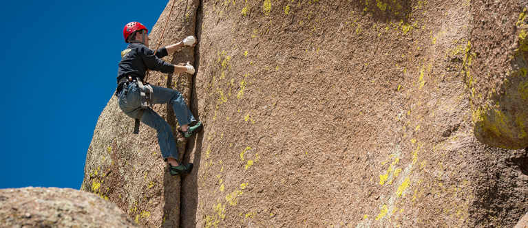Image of a man rock climbing