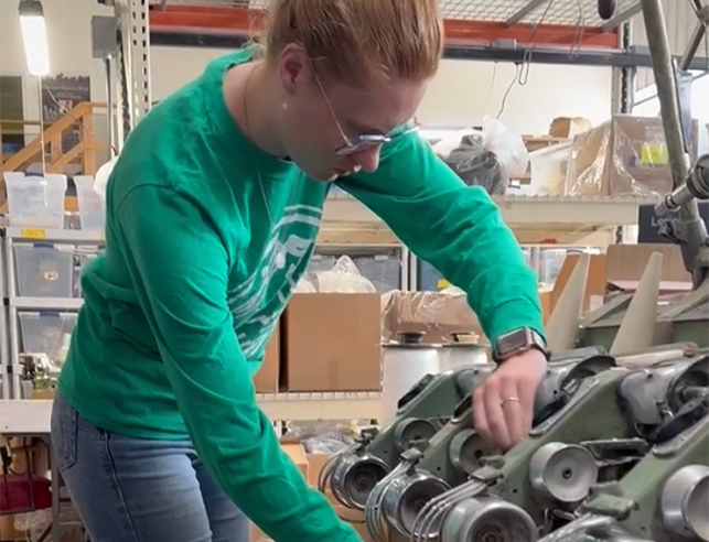 Family and Consumer sciences student, Allie Van Why strings wool through a threading machine during her internship