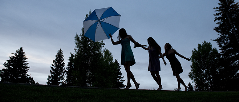 3 dietetics students walking in silhouette