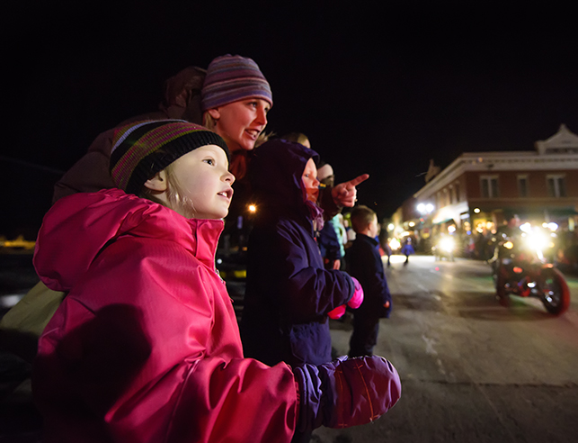 a parent and child pointing off screen