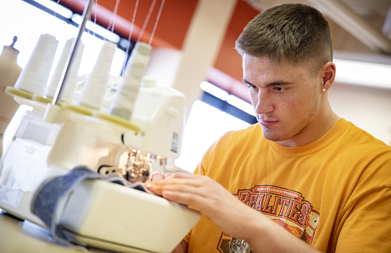 a family and consumer sciences student sewing