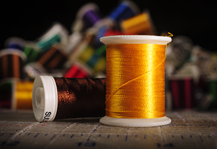 a pair of spools of thread from the family and consumer sciences sewing lab