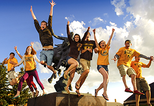 a dozen family and consumer sciences students leaping for joy