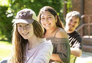 three family and consumer sciences students smiling at the camera