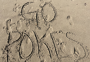 the phrase go pokes etched into the sand by a family and consumer sciences major