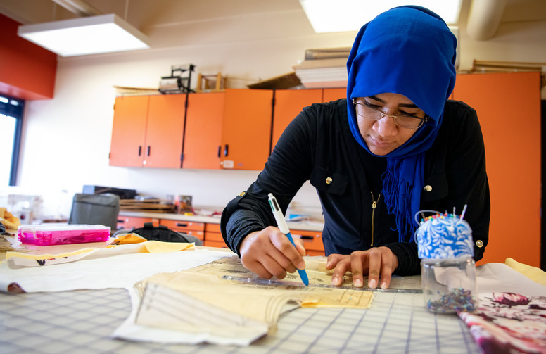 Student making pattern in sewing lab