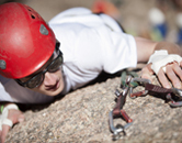 A University of Wyoming student with helmet climbs rocks at Vedauwoo, one potential activity of the Outdoor Leadership FIG.