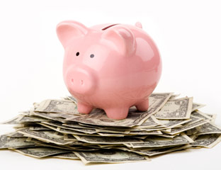 Piggy bank on a pile of dollar bills