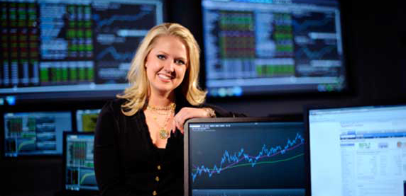 woman standing in front of stock computers