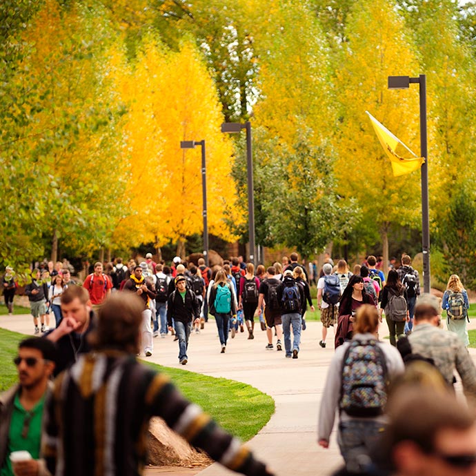 students walking on campus in autumn