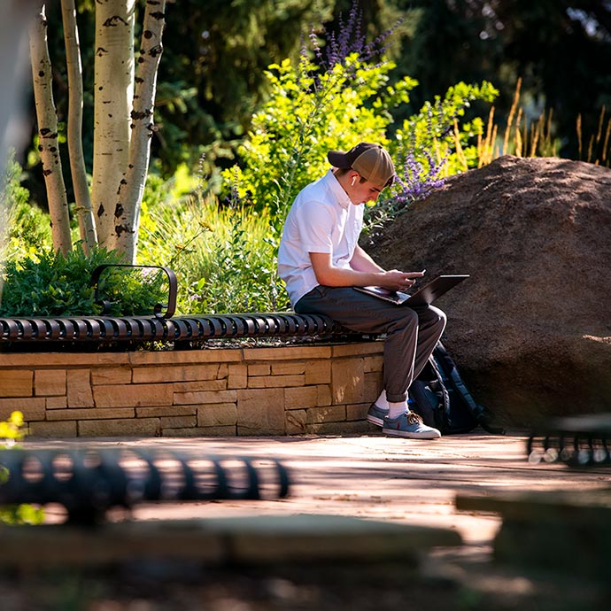 student on bench studying