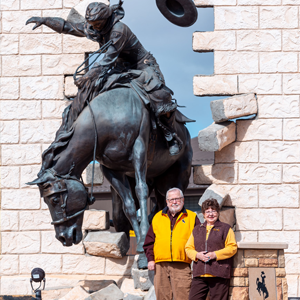 Doc and Karen Schroeder in front of Breaking Through
