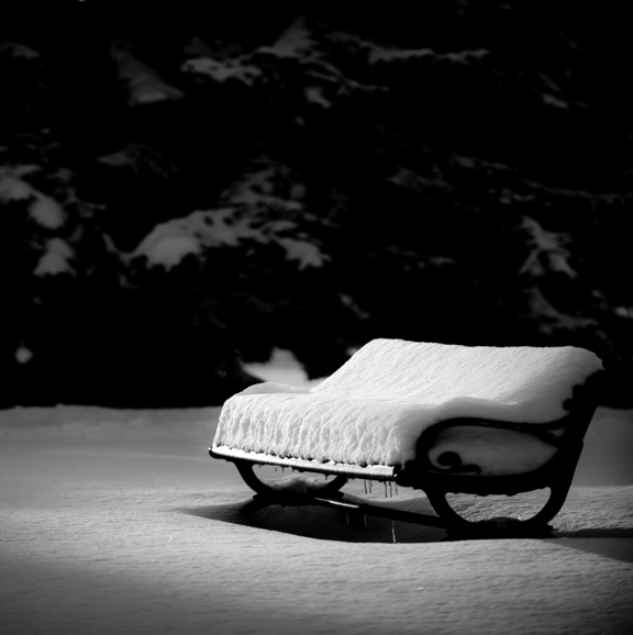 bench covered in a lot of snow