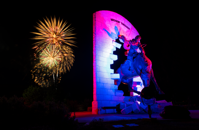 bucking horse statue with fireworks