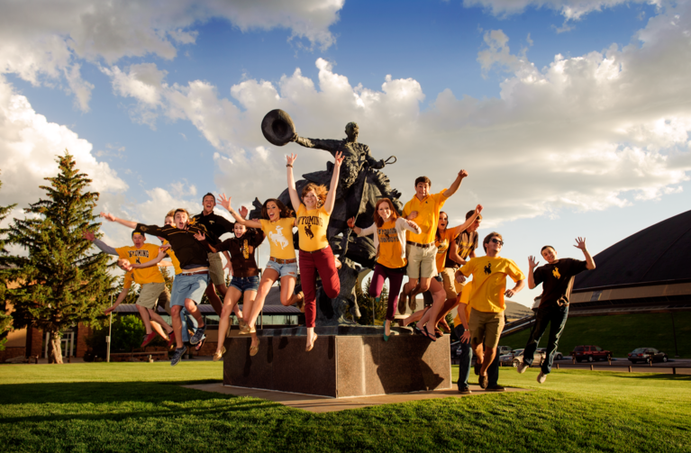 students jumping on campus