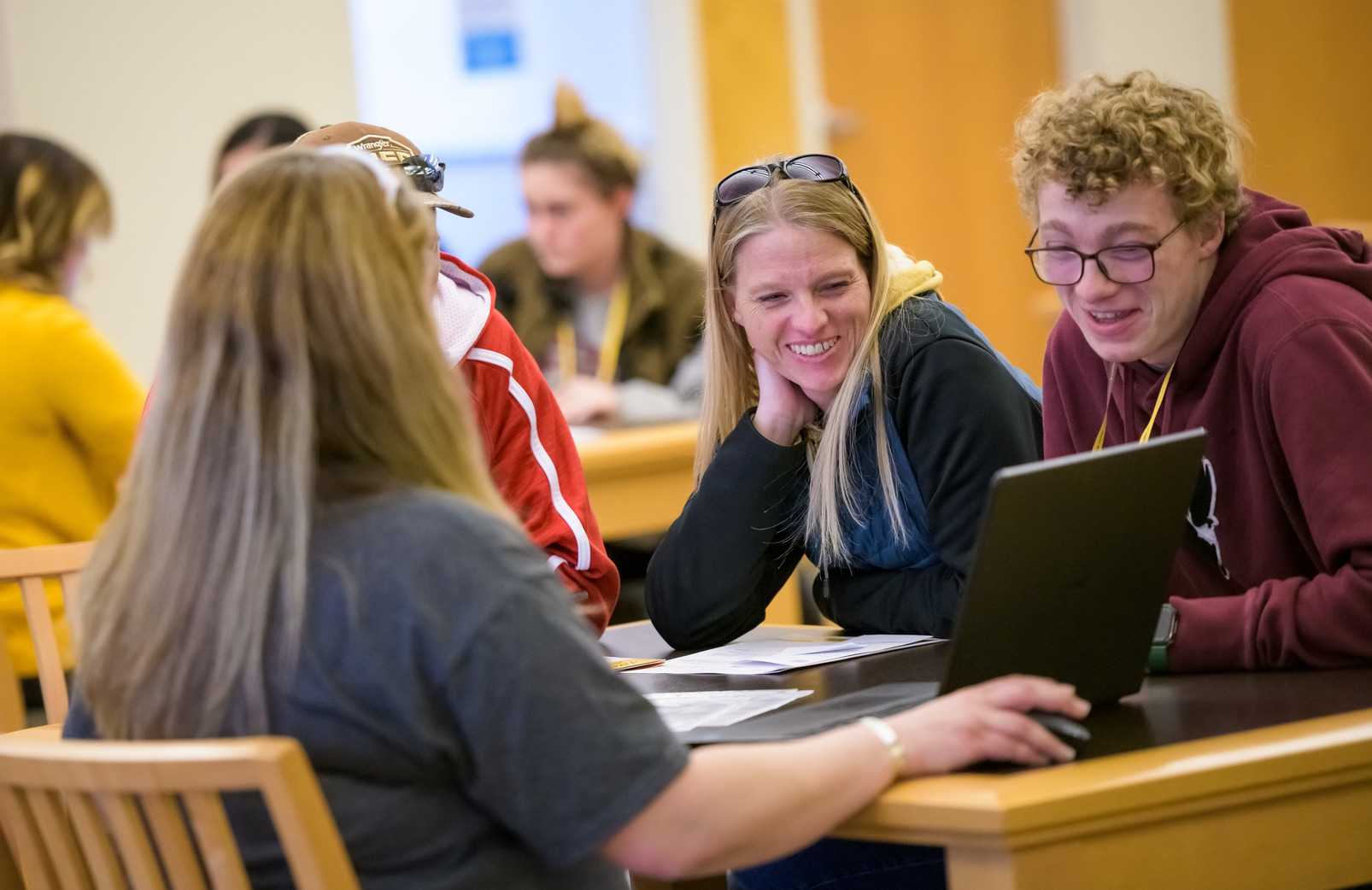 student and family looking at laptop