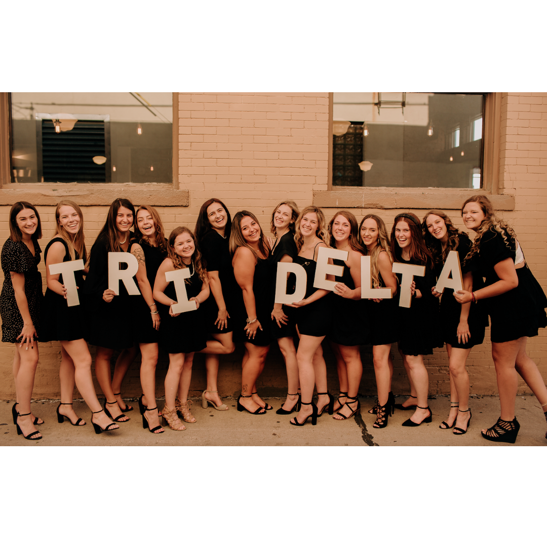 sisters holding tri delta letters