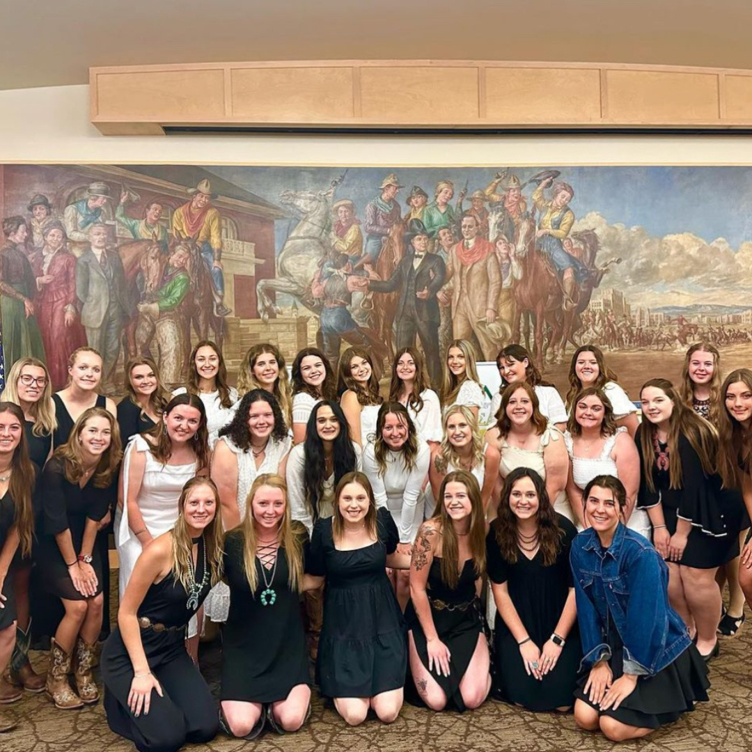 sisters in front of mural