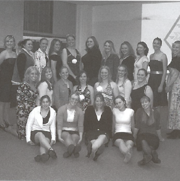 Black and white group photo of the women on Sigma Alpha in dresses
