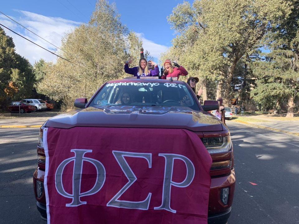 two members of phi sigma rho after the impact leadership retreat doing their sorority hand sign