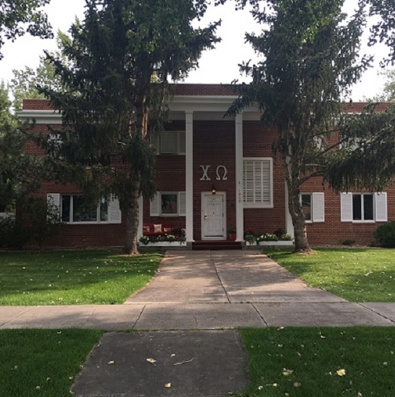 Chi Omega house with letters displayed over the door.