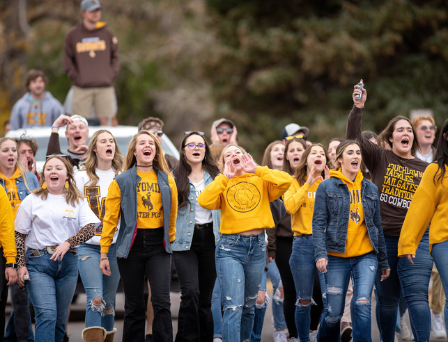 A group of students from fraternities and sororities cheer in the parade