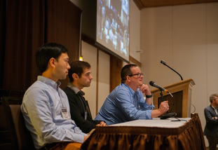 A group of panel members lead a discussion at a conference