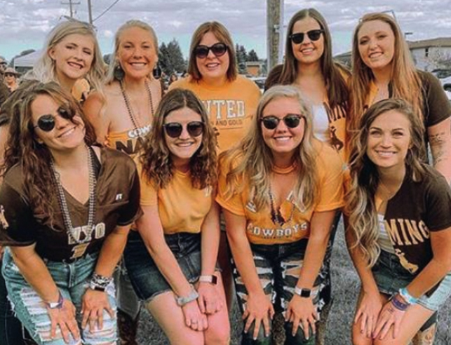 Female students in Wyoming Cowboys gear at homecoming