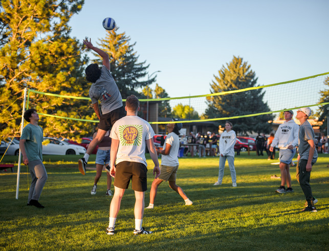 A group of students play volleyball during Cowboy Carnival
