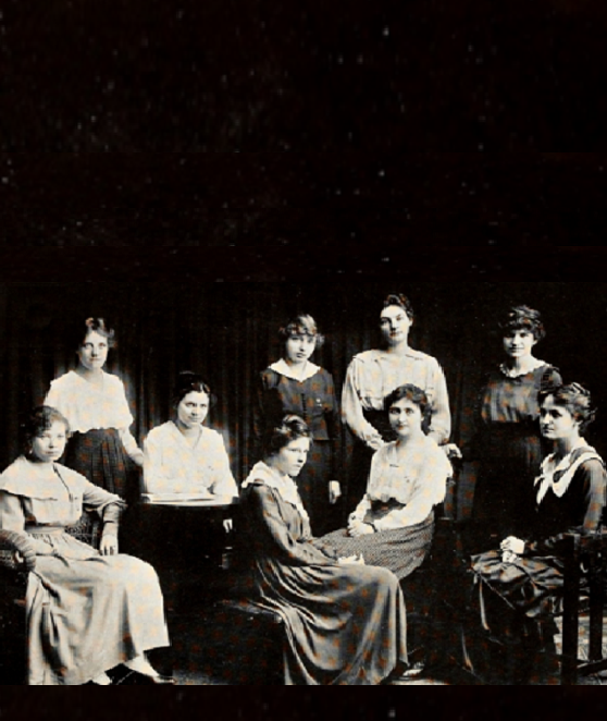 3 women from each sorority posing for a group photo, some sitting and some standing. 