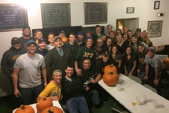 Group of AGRs and Sigma Alphas posing for a picture after a pumpkin carving social