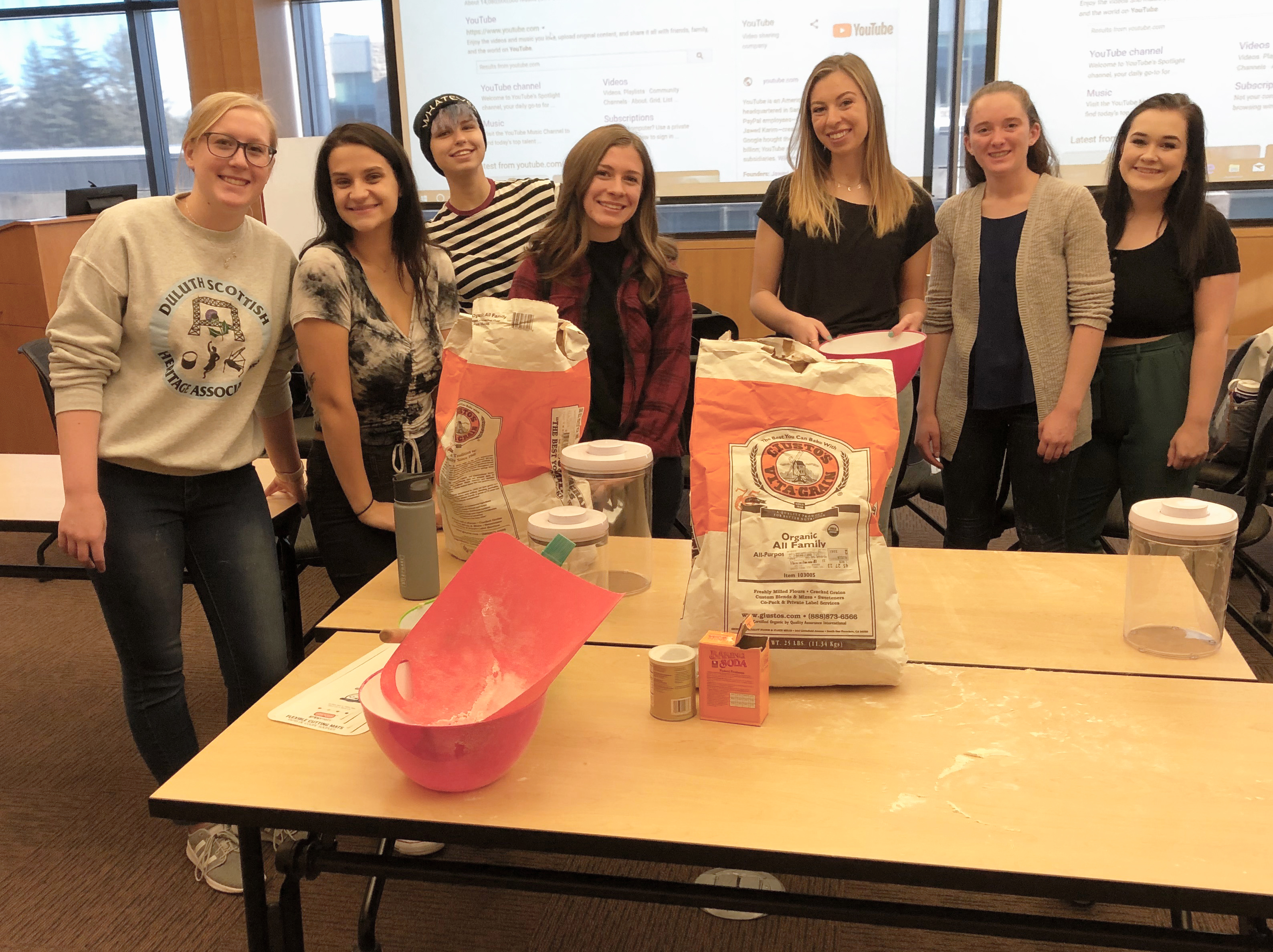 students stop to pose for picture during the assembly of the ginger bread  jars