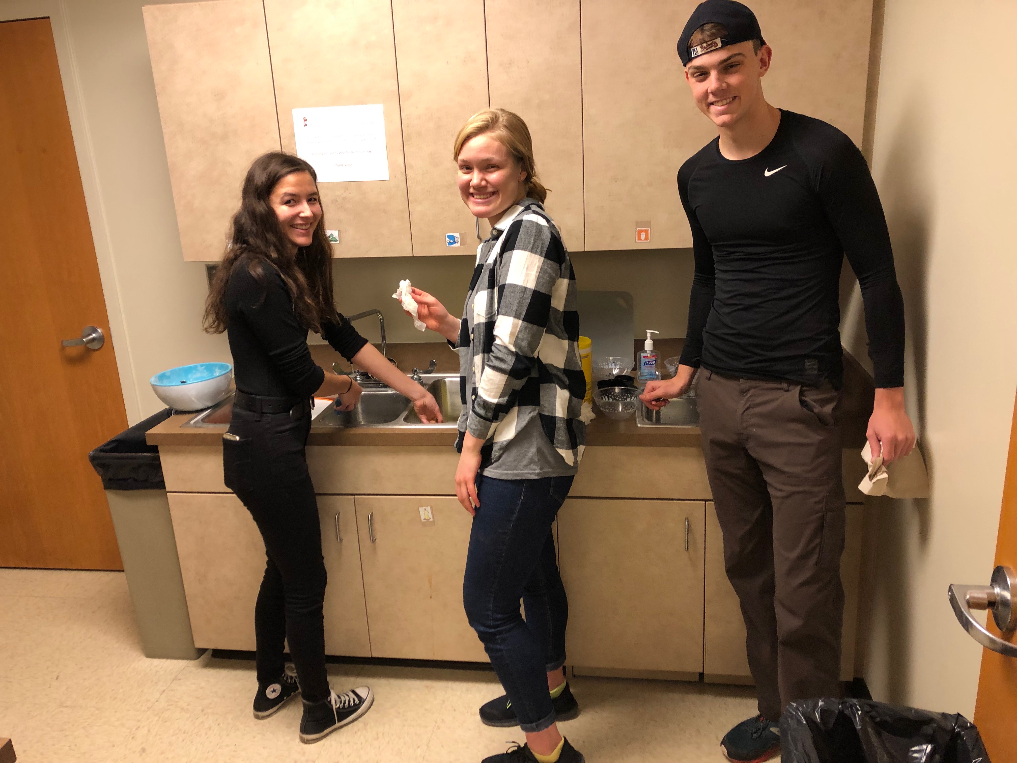 students assemble jars of gingerbread ingredients