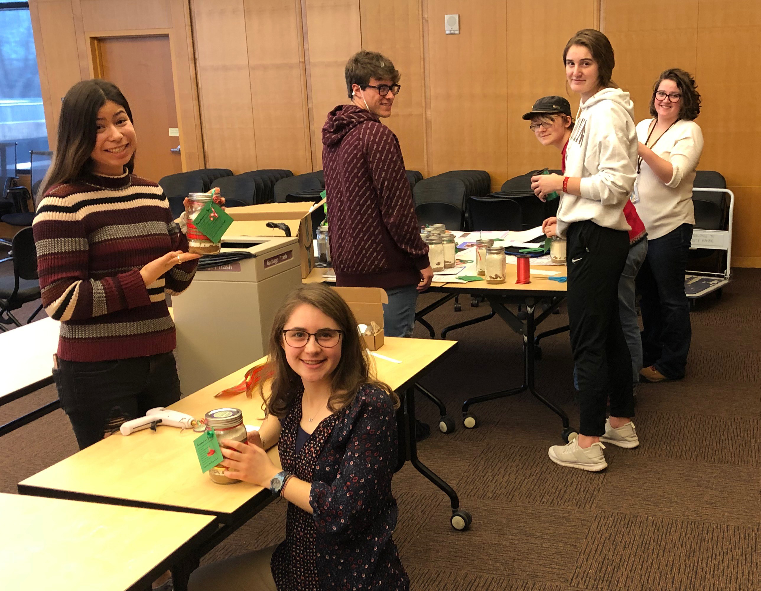 students work to assemble the mason jars