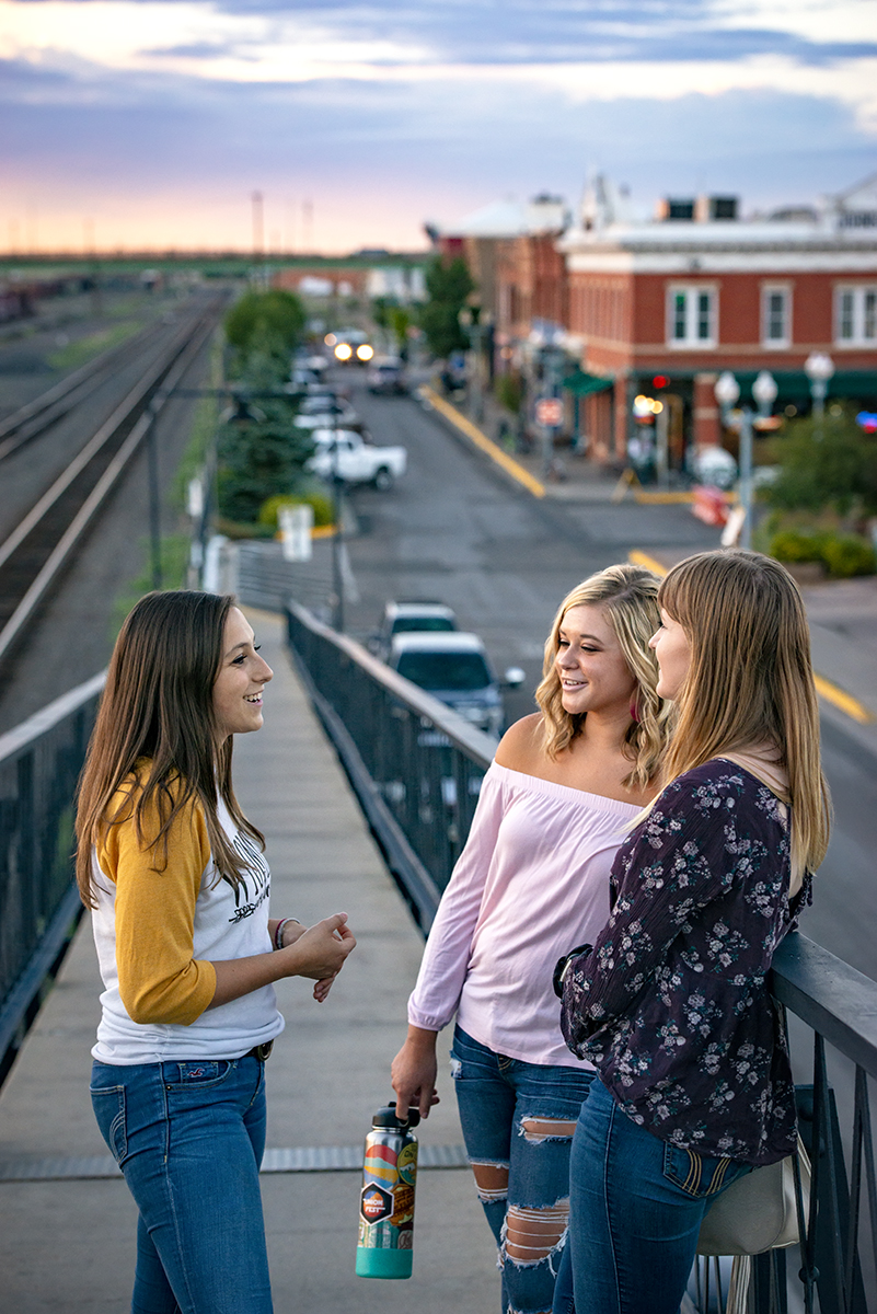 Students pose on footbridge downtown