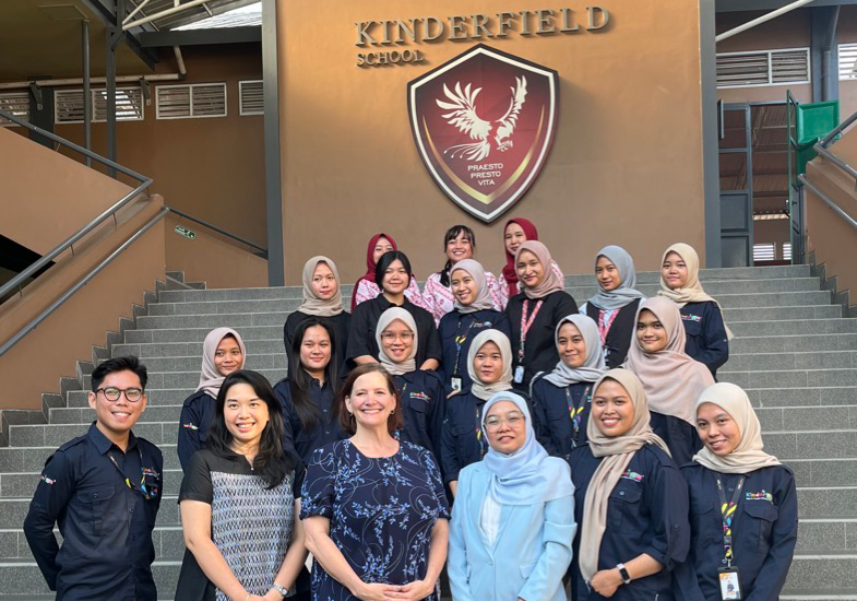 Teachers pose on steps of Jambi's Kindergym