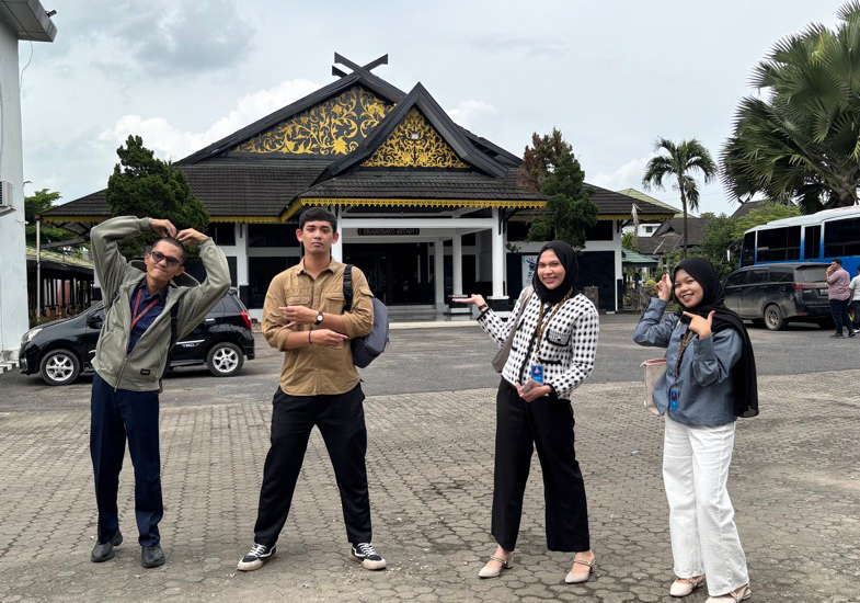 four TNLID Team members show the Language Center in Jambi, Indonesia