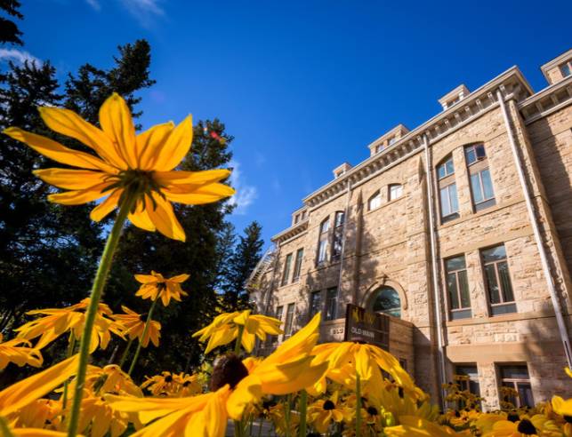 Flowers in front of Old Main on campus at the University of Wyoming