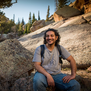 student sits on rock at Vedauwoo