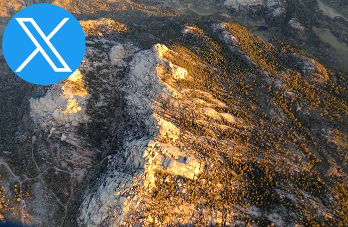 Rock formation with Twitter icon in the top left corner