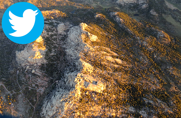 Rock formation with Twitter icon in the top left corner