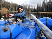 Man in kayak on mountain lake