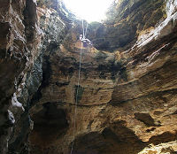 A researcher descends into the natural trap cave in the Big Horn Mountains two summers ago.