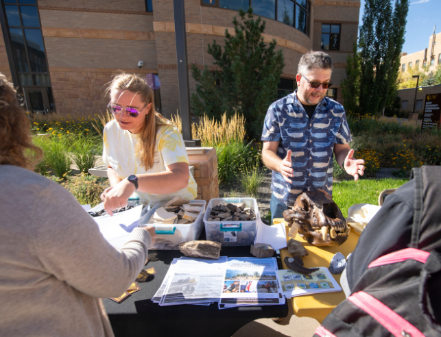 museum staff at outdoor outreach event with skulls