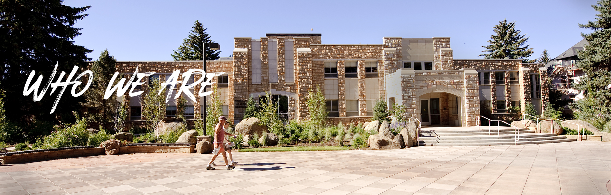 People walking on campus past the Cheney International Center Building